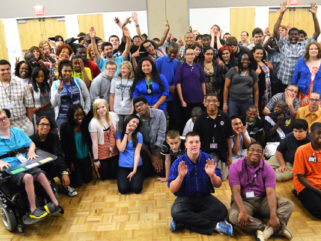 A large group of students pose for a picture.